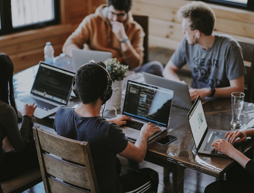 A team working together around a laptop