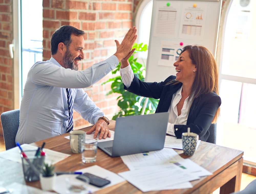 Two people reviewing work together